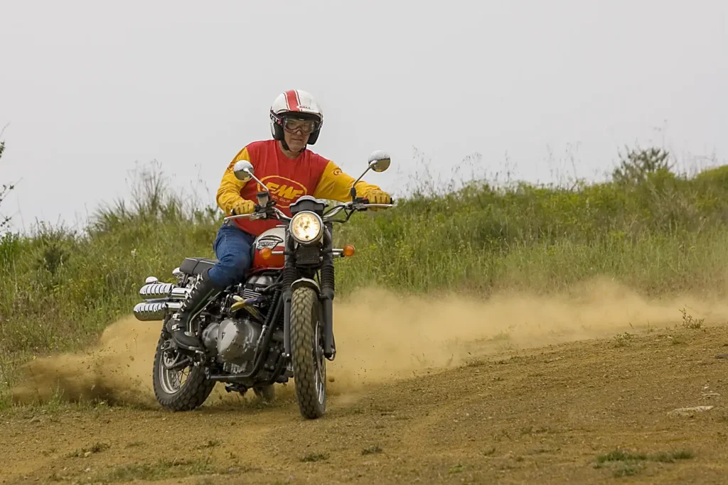 A rider doing a powerslide on a 2006 Triumph Scrambler.