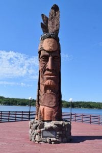 The statue of Nee-Gaw-Nee-Gaw-Bow was carved by Peter Wolf Toth from a single pine log from the Ottawa National Forest.