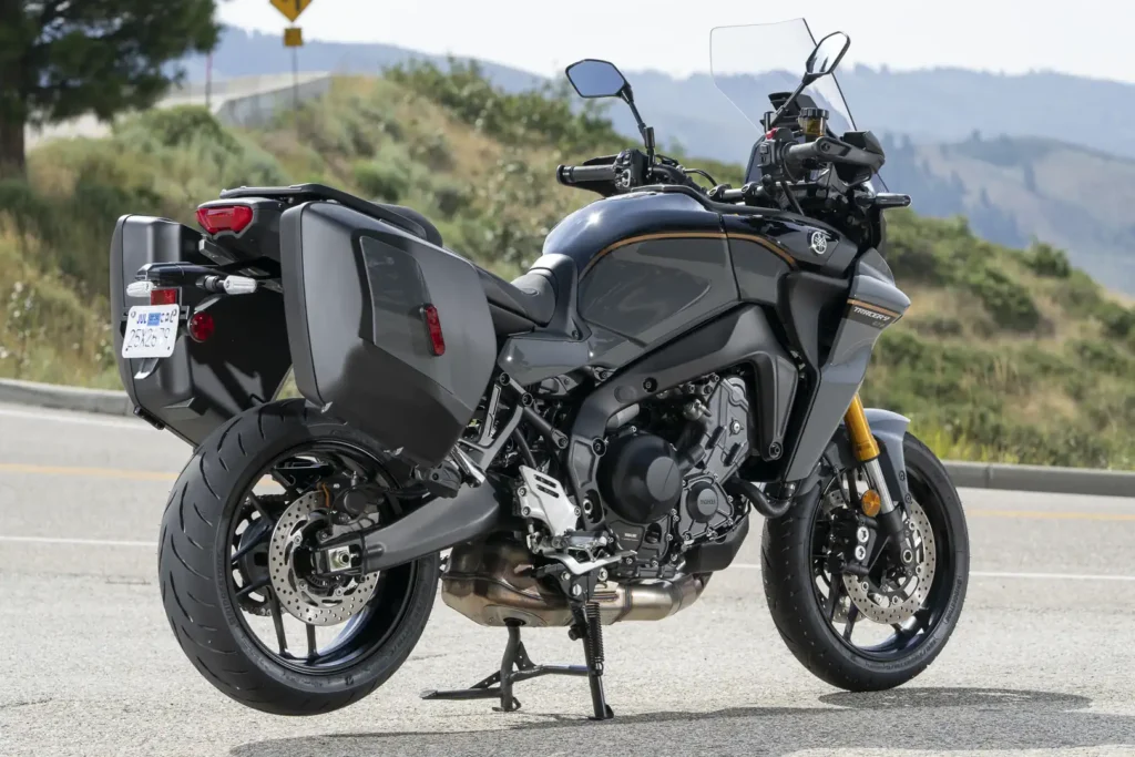 2024 Yamaha Tracer 9 GT+ on its centerstand with side cases, rear three-quarter view