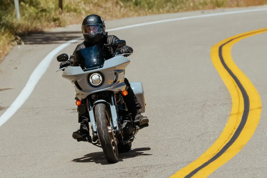 Cardo Mesh Boost Doubles Packtalk Group Size to 31 Riders: Packtalk Pro being used while riding a Harley-Davidson Low Rider ST