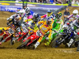 2027 AMA Supercross and Motocross Rider Numbers: SMX, Too! Riders in the first turn at a supercross race.