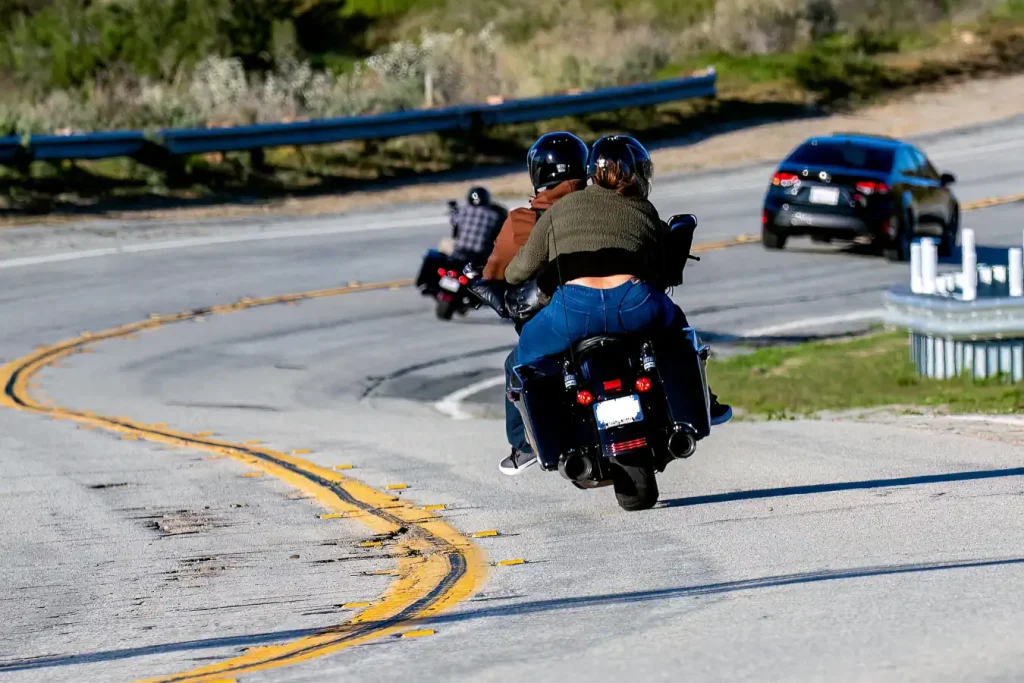 Motorcycles on deteriorating pavement