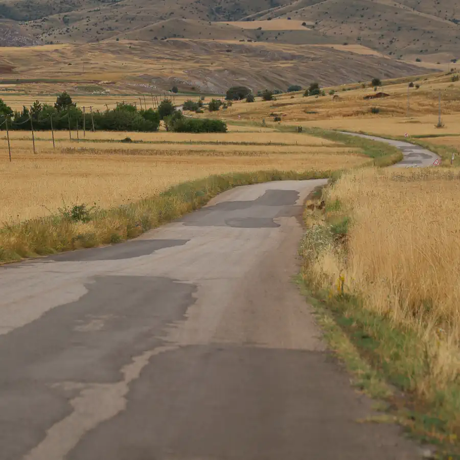 The 10 Worst States for Road Conditions and Deadly Crashes: Patchy pavement on rural road