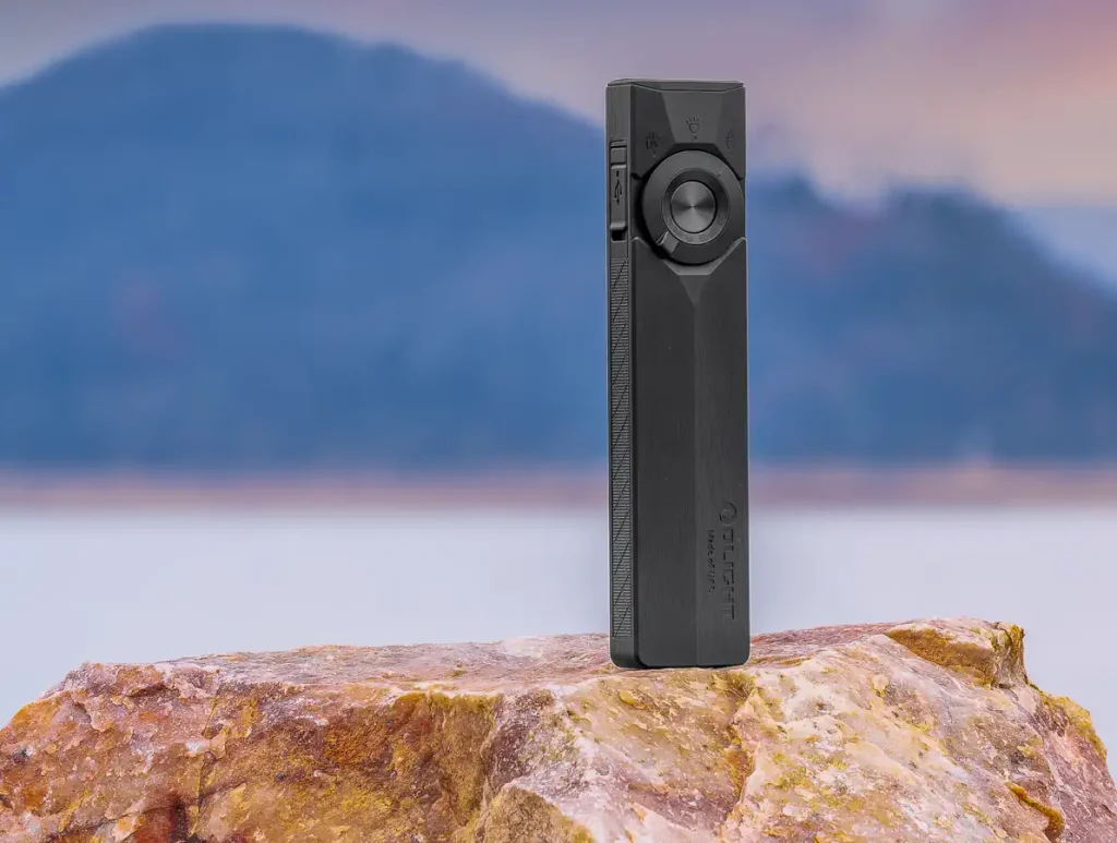 Olight ArkPro Ultra Flashlight Review: On location on a rock at a lake.