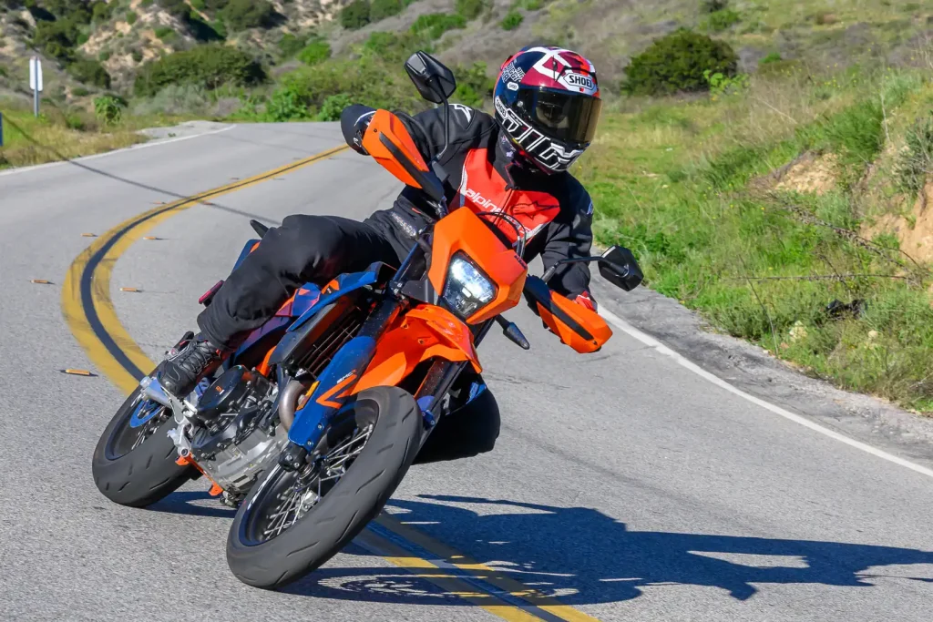 2026 KTM 690 SMC R Review: Riding the motorcycle through a left-hand corner.