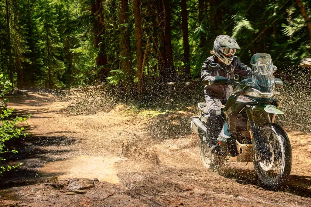 2027 CFMoto Ibex 950 Adventure Bike First Look: motorcycle splashing through a puddle