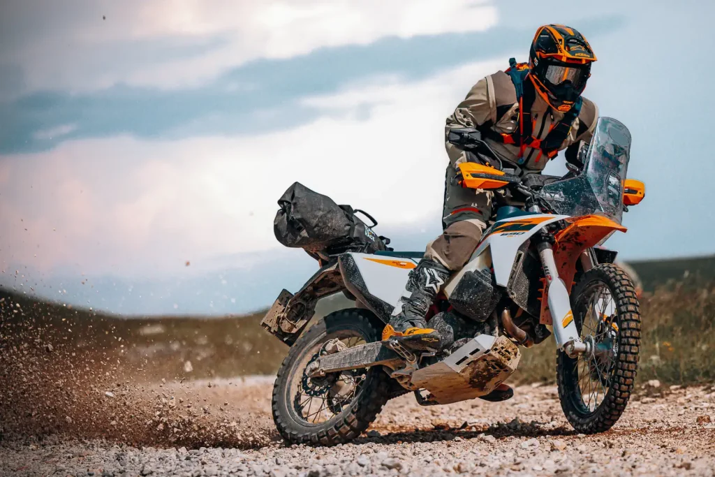2027 KTM 690 Rally power slide in the gravel.
