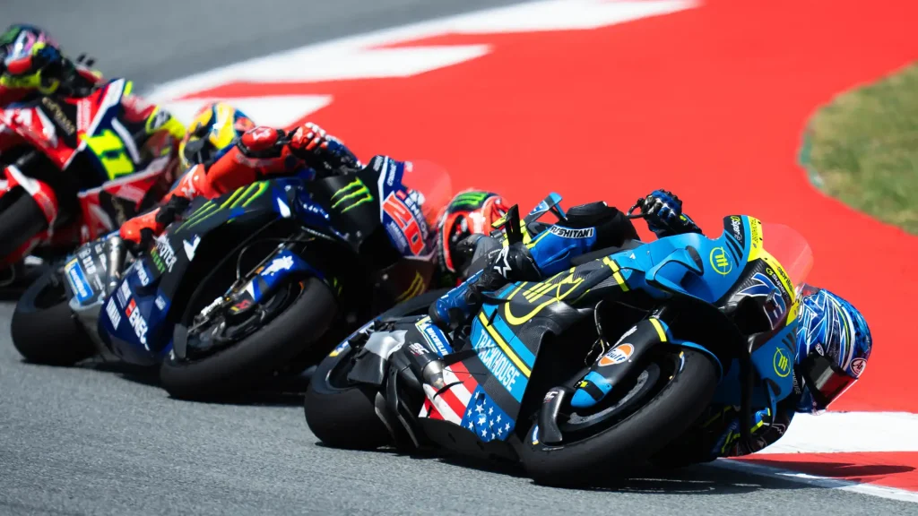 Ai Ogura, Fabio Quartararo, and Luca Marini leaning to the left in that order.