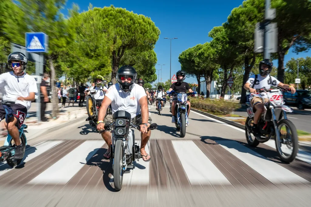 50cc motorcycles and mopeds riding down the street