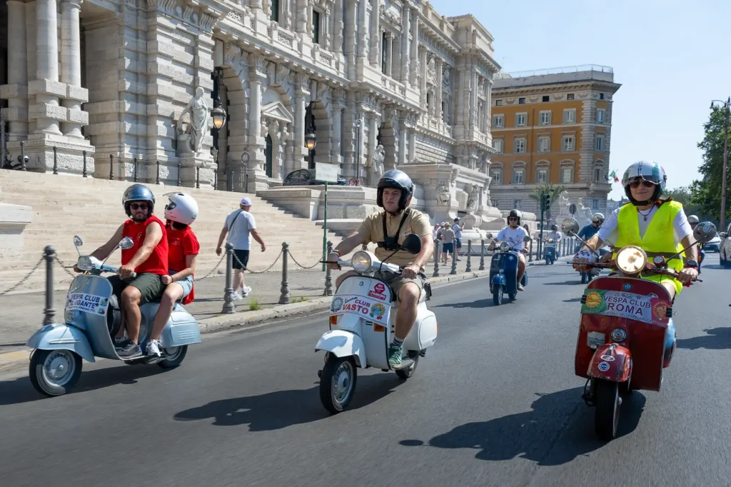 Three scooters riding through Rome