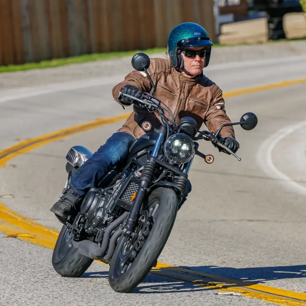 2026 Honda SCL500 being ridden through a left-hand corner with Don Williams aboard.