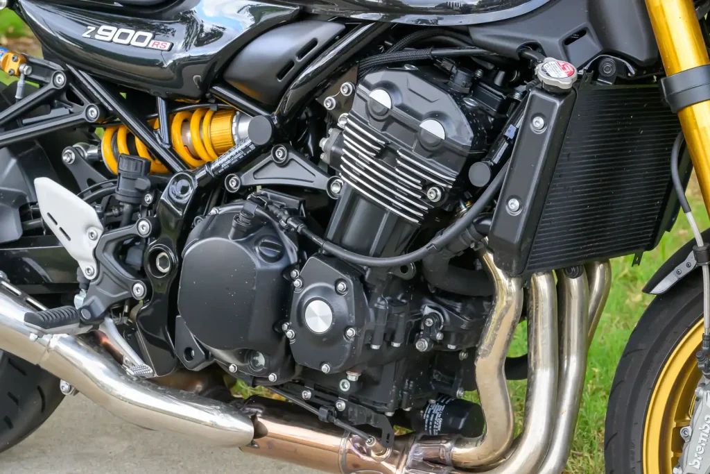 Right side of the inline-4 engine powering the 2026 Kawasaki Z900RS SE, including headers and Ohlins shock
