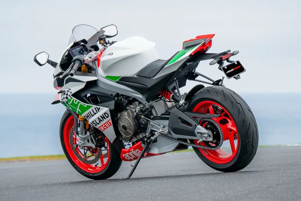 Left 3/4 rear view of the 2027 Aprilia RS 660 Phillip Island Tribute on the circuit tarmac.
