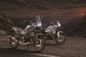 Kawasaki KLE650 SE and standard KLE650 parked on a mountain road at dusk