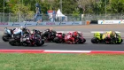 2027 MotoGP Riders and Rules: The Great Reset MotoGP riders leaned over in a right hand turn during a race.