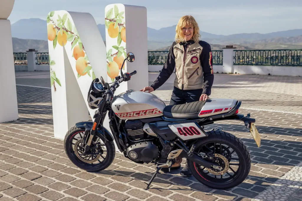 2027 Triumph Tracker 400 Review: Author Kelly Callan posing with the bike, showing the left side.