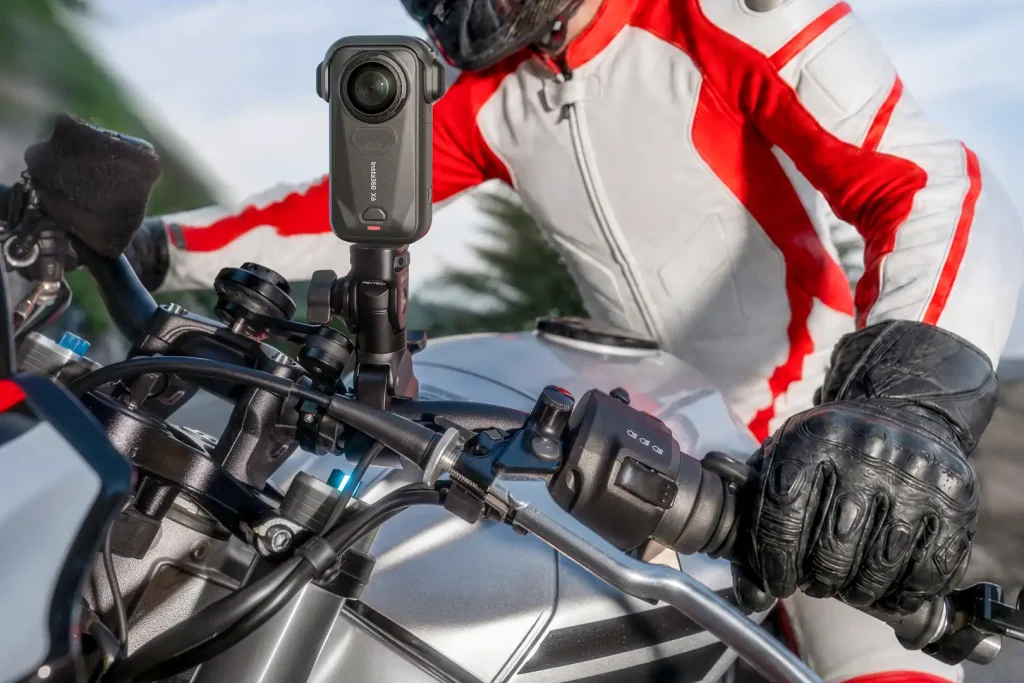Stock photo of an action camera mounted on a motorcycle with a rider behind it.