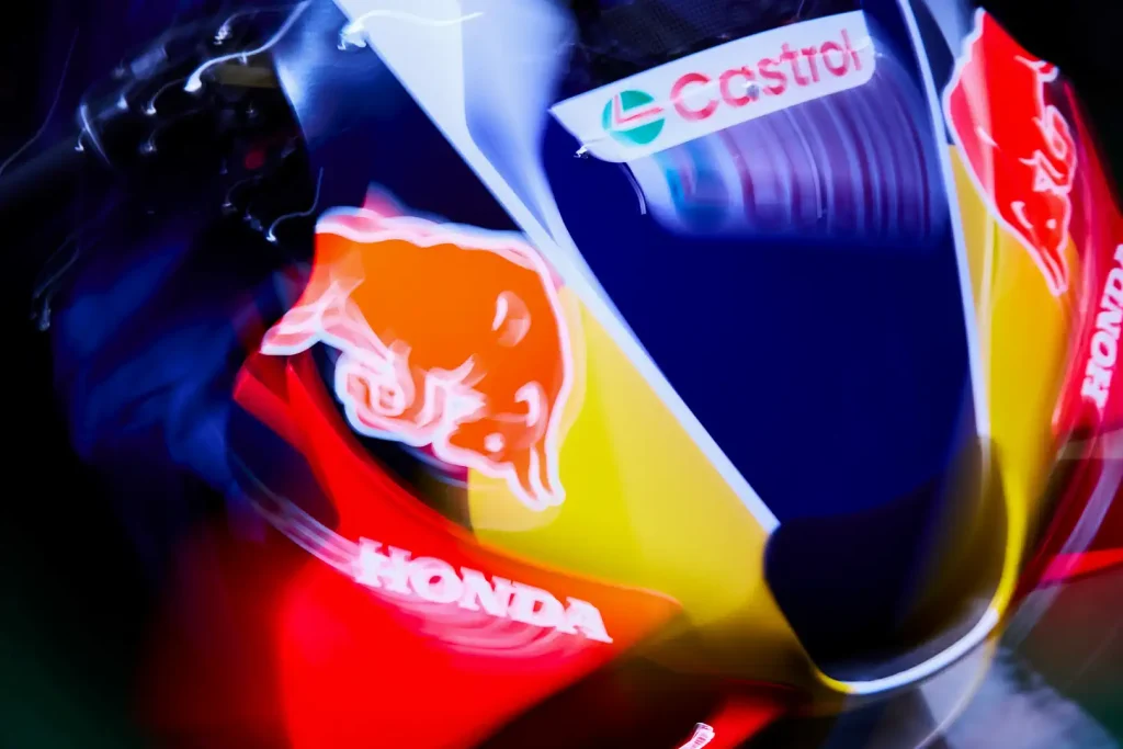 An overhead artistically blurred photo of the top front of Honda's 2027 MotoGP bike with Red Bull logos