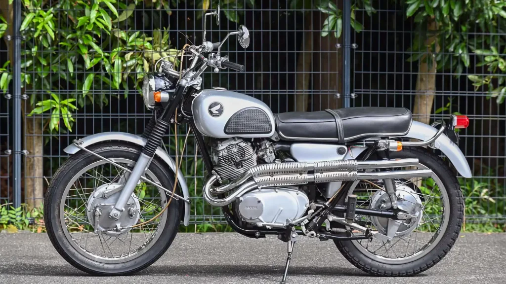 Scrambler Motorcycle History: 1962 Honda CL72 parked outside.