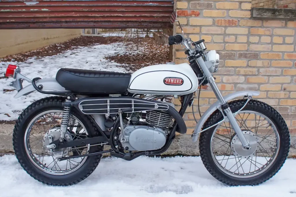 Right side of a 1968 Yamaha DT-1 parked in the snow.